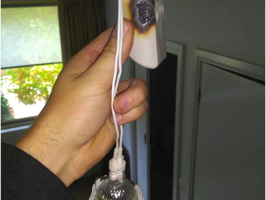 Scorched downlight and burnt ceiling around a halogen lamp