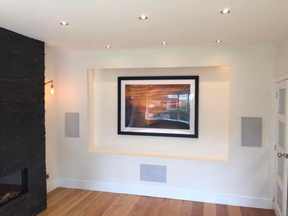 Ceiling downlights and a wall light in a finished living room